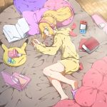  1girl alternate_costume bed blonde_hair book closed_mouth computer green_eyes headphones hood hood_down laptop lillie_(pokemon) long_hair long_sleeves lying mifa nintendo_switch on_side open_book pillow pokemon pokemon_(game) pokemon_sm ponytail shorts slippers solo 
