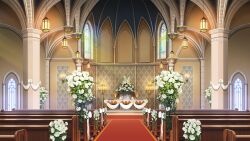  arched_window bouquet candelabra candlestand ceiling_light chandelier checkered_floor church curtains flower glowing highres indoors no_humans non-web_source official_art our_life our_life:_beginnings_and_always pew plant podium poppy_(flower) potted_plant scenery stained_glass table variant_set white_flower window wooden_table 