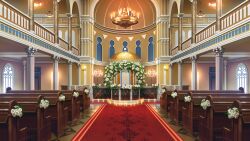  arch bouquet candelabra candlestand chandelier flower hanging_light highres indoors no_humans non-web_source official_art our_life our_life:_beginnings_and_always pew poppy_(flower) railing red_carpet scenery synagogue temple tile_floor tiles variant_set wedding_arch white_flower window 