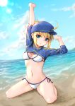  1girl absurdres ahoge artoria_pendragon_(all) baseball_cap beach bikini blonde_hair blue_eyes blue_headwear blush breasts clouds commentary_request day eyebrows_visible_through_hair fate/grand_order fate_(series) hair_through_headwear hat highres itachi_class kneeling looking_at_viewer mysterious_heroine_xx_(foreigner) navel outdoors ponytail shrug_(clothing) side-tie_bikini smile solo swimsuit water white_bikini 