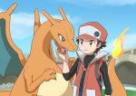  1boy backpack black_hair blue_eyes brown_eyes cap charizard enon fangs hand_on_another&amp;#039;s_chin hat long_sleeves looking_at_each_other pokemon pokemon_(creature) pokemon_(game) red_(pokemon) smirk tongue vest 