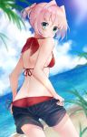  1girl ass beach bikini black_shorts blue_eyes blue_sky clouds commentary_request cowboy_shot day dutch_angle from_behind hair_ornament highres horizon kantai_collection looking_back ocean outdoors pink_hair ponytail red_bikini shiranui_(kantai_collection) short_hair short_ponytail shorts sky solo standing swimsuit u_yuz_xx undressing water 