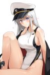  1girl azur_lane black_gloves blue_eyes blush breasts cape closed_mouth collarbone competition_swimsuit enterprise_(azur_lane) fingerless_gloves gloves half_gloves harukon_(halcon) hat knee_up large_breasts looking_at_viewer one-piece_swimsuit peaked_cap sideboob sidelocks silver_hair simple_background sitting solo swimsuit white_background white_headwear white_swimsuit 