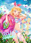  1girl 2016 :d aikatsu! aikatsu!_(series) bikini blonde_hair blush bow breasts clouds cloudy_sky commentary_request cowboy_shot day floating_hair frilled_bikini frills hair_bow hairband hand_behind_head holding holding_innertube hoshimiya_ichigo innertube katou_akatsuki long_hair navel open_mouth plant red_eyes round_teeth side-tie_bikini sky small_breasts smile solo summer swimsuit teeth upper_teeth 