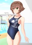  1girl absurdres black_swimsuit blurry breasts brown_hair collarbone commentary_request competition_swimsuit cowboy_shot day depth_of_field floral_print green_eyes highres kantai_collection large_breasts mutsu_(kantai_collection) no_headgear one-piece_swimsuit outdoors pool short_hair solo standing swimsuit takafumi 