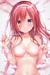  1girl amedamacon bangs bed_sheet blue_eyes blush bow bow_bra bra breasts closed_mouth collarbone commentary_request eyebrows_visible_through_hair fingernails go-toubun_no_hanayome hair_between_eyes hands_up long_hair looking_at_viewer lying medium_breasts nakano_miku navel on_back petals red_eyes smile solo strap_slip twitter_username underwear underwear_only upper_body white_bra 