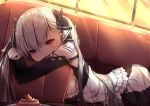  1girl azur_lane backlighting bangs bare_shoulders black_dress blush breasts cake couch dress earrings eyebrows_visible_through_hair food formidable_(azur_lane) frilled_dress frills grey_hair hair_ornament hair_ribbon highres indoors jewelry large_breasts long_hair long_sleeves looking_at_viewer lying on_stomach red_eyes ribbon solo sunset twintails umou_(may65879) 