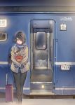  1girl bag bangs black_eyes black_hair blue_gloves blue_scarf brown_bag brown_coat coat daito full_body gloves ground_vehicle hair_over_one_eye highres holding holding_bag original pants scarf solo suitcase swept_bangs train train_station 