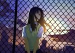  1girl ahoge bangs black_bow black_eyes black_hair black_skirt bow chain-link_fence clouds collared_shirt commentary_request covered_mouth dress_shirt eyebrows_visible_through_hair fence floating_hair long_hair looking_away looking_to_the_side original outdoors pleated_skirt school_uniform shirt skirt sky skyline solo sunset sweater_vest upper_body urata_asao v_arms white_shirt 