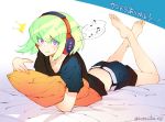  1boy barefoot bed earrings green_hair headphones hotaruika_niji jewelry lio_fotia looking_at_viewer lying male_focus on_stomach open_mouth pillow pillow_hug promare short_hair shorts signature solo surprised violet_eyes 