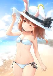  animal_ears beach bikini breasts brown_eyes brown_hair hat highres ikazuchi_(kantai_collection) kantai_collection one_eye_closed outdoors rabbit_ears side-tie_bikini small_breasts strapless strapless_bikini swimsuit wamu_(chartreuse) 