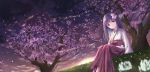  1girl absurdres bangs black_hair blunt_bangs blush cherry_blossoms closed_mouth flower grass hair_flower hair_ornament hakama highres hip_vent japanese_clothes keima_ron long_hair looking_at_viewer miko original petals pink_eyes scenery sitting smile solo sunset tree wide_sleeves 