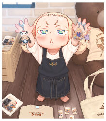  1girl :&lt; apron arms_up barefoot black_apron blonde_hair blue_eyes blush brick_wall closed_mouth commentary_request denim_apron forehead indoors kozato_(yu_kozato) little_blonde_girl_(kozato) long_sleeves original shirt short_eyebrows solo standing stuffed_animal stuffed_toy teddy_bear thick_eyebrows twintails v-shaped_eyebrows white_shirt wooden_floor 