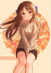  1girl aran_sweater autumn_leaves beige_sweater between_legs black_shorts blue_bow blush bow brown_eyes brown_hair commentary eyebrows_visible_through_hair feet_out_of_frame hair_bow hand_between_legs head_tilt highres idolmaster idolmaster_cinderella_girls light_smile long_hair long_sleeves looking_at_viewer nagononn outline short_shorts shorts sitting solo sweater tachibana_arisu white_outline 