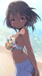  1girl arms_behind_back beach bikini_top black_hair blue_shorts breasts closed_mouth dark_skin floral_print idolmaster idolmaster_cinderella_girls looking_at_viewer mashou_boy medium_breasts natalia_(idolmaster) sand short_hair shorts smile solo violet_eyes water 