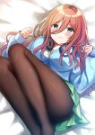  1girl :t bangs bed_sheet blue_cardigan blue_eyes blush breasts brown_hair brown_legwear cardigan closed_mouth commentary_request eyebrows_visible_through_hair feet_out_of_frame go-toubun_no_hanayome green_skirt hair_between_eyes headphones headphones_around_neck highres large_breasts long_hair long_sleeves lying minami_saki nakano_miku no_shoes on_back pantyhose pleated_skirt pout shirt skirt sleeves_past_wrists solo white_shirt 