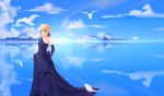  1girl absurdres ahoge artoria_pendragon_(all) asymmetrical_clothes bird blonde_hair blue_dress blue_ribbon blue_sky braid clouds collarbone dress elbow_gloves er_ci_gudu evening_gown fate/grand_order fate_(series) feathers french_braid gloves green_eyes hair_between_eyes highres ocean petals ribbon saber sky smile solo water 