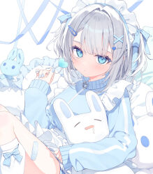  1girl apron bandaid bandaid_on_leg blue_eyes blue_jacket blue_nails blue_ribbon blue_track_suit candy closed_mouth feet_out_of_frame food frilled_apron frilled_pillow frills hair_intakes hair_ornament hair_ribbon hairclip hand_up heart heart-shaped_food highres holding holding_candy holding_food holding_stuffed_toy jacket jersey_maid kneehighs leg_bow long_sleeves looking_at_viewer loose_socks maid maid_apron maid_headdress original pillow ribbon ryouka_(suzuya) short_hair sitting sleeves_past_wrists socks solo stuffed_animal stuffed_rabbit stuffed_toy tenshi_kaiwai track_jacket track_suit turtleneck turtleneck_jacket unconventional_maid white_apron white_hair white_socks x_hair_ornament zipper_pull_tab 