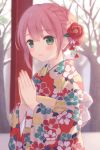  1girl bangs bare_tree blurry blurry_background blush braid brown_hair closed_mouth commentary_request depth_of_field eyebrows_visible_through_hair floral_print flower furisode green_eyes hair_between_eyes hair_flower hair_ornament hands_together hands_up highres japanese_clothes kazane_mari kimono obi original own_hands_together palms_together print_kimono red_flower red_kimono sash smile solo tree upper_body 