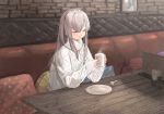  1girl cable_knit closed_eyes commentary_request cup grey_hair hair_between_eyes highres holding_drink idolmaster idolmaster_shiny_colors long_sleeves mug pillow plate polka_dot seisei_tamago sitting smile solo steam sweater table wooden_table yuukoku_kiriko 