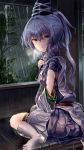  1girl blue_eyes commentary_request detached_sleeves eyebrows_visible_through_hair full_body hat highres japanese_clothes kariginu looking_at_viewer looking_back mononobe_no_futo parted_lips ponytail rain sensi_tobikage silver_hair sitting socks solo tate_eboshi touhou tree wariza wet wet_clothes wet_hair white_legwear 