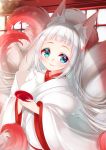  1girl animal_ear_fluff animal_ears aqua_eyes bangs blue_eyes blurry blurry_background closed_mouth commentary_request cup depth_of_field fox_ears fox_girl fox_tail heterochromia highres holding japanese_clothes kimono kitsune long_hair long_sleeves looking_at_viewer miko mirai_(happy-floral) original sakazuki smile solo tail very_long_hair white_hair white_kimono wide_sleeves 