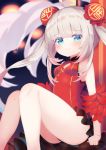  1girl :3 ahoge azur_lane bangs bare_shoulders blue_eyes blurry blurry_background blush breasts bun_cover character_request china_dress chinese_clothes closed_mouth commentary_request depth_of_field double_bun dress eyebrows_visible_through_hair feet_out_of_frame grey_hair highres koko_ne_(user_fpm6842) looking_at_viewer red_dress sidelocks sitting sleeveless sleeveless_dress small_breasts solo twintails 