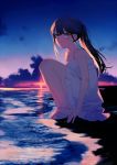  1girl achiki bare_legs bare_shoulders beach black_hair clouds commentary_request dress gradient_sky green_eyes knees_up long_hair looking_at_viewer ocean original outdoors ponytail sandals sitting sky sleeveless sleeveless_dress solo spaghetti_strap sundress sunset water white_dress 