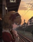  1girl asagi_noko blonde_hair bow bowtie clouds collar commentary_request dusk expressionless frilled_collar frilled_hairband frills green_eyes hair_bow hairband hand_on_own_chest highres idolmaster idolmaster_cinderella_girls lolita_hairband long_sleeves outdoors overhead_line profile railroad_tracks red_bow red_neckwear sakurai_momoka scenery short_hair sign sky solo telephone_pole train_station train_station_platform tree twilight upper_body wavy_hair 