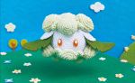  amigurumi_(medium) asako_ito commentary cottonee creature english_commentary full_body gen_5_pokemon multiple_sources no_humans official_art photo pokemon pokemon_(creature) pokemon_trading_card_game solo third-party_source 