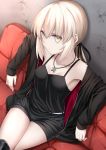  1girl absurdres artoria_pendragon_(all) belt black_camisole black_jacket black_ribbon black_shorts blonde_hair boots breasts cross cross_necklace fate/grand_order fate_(series) highres hino_(2nd_life) jacket jet_black_king_of_knights_ver._shinjuku_1999 jewelry knee_boots low_ponytail necklace ribbon royal_brand saber_alter short_shorts shorts sitting small_breasts solo white_belt yellow_eyes 