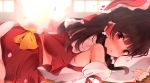  1girl bandages bangs bare_shoulders blurry blurry_background blush bow brown_hair commentary_request detached_sleeves eyebrows_visible_through_hair frilled_bow frills from_side hair_bow hair_tubes hakurei_reimu heart hunya long_hair long_sleeves looking_at_viewer lying nontraditional_miko nose_blush on_stomach open_mouth petals pillow pillow_hug red_bow red_eyes red_shirt red_skirt shirt skirt sleeveless sleeveless_shirt solo touhou yellow_bow 