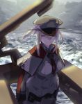  1girl blonde_hair breasts capelet celtic_knot clouds graf_zeppelin_(kantai_collection) grey_eyes grey_sky hair_between_eyes hat iron_cross jacket kantai_collection large_breasts machinery military military_hat military_uniform necktie ocean peaked_cap sidelocks solo tsurime twintails uniform upper_body waves yamaioni_(sasakama) 