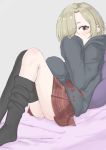  1girl absurdres black_hoodie black_legwear blonde_hair blush covering_mouth ear_piercing grey_background hair_over_one_eye highres hood hood_down hoodie idolmaster idolmaster_cinderella_girls knees_together_feet_apart kuzuuo leaning_back looking_at_viewer multiple_piercings on_bed oversized_clothes piercing pillow plaid plaid_skirt pleated_skirt red_eyes red_skirt shirasaka_koume short_eyebrows short_hair sitting skirt sleeves_past_fingers sleeves_past_wrists solo thigh-highs thighhighs_pull 