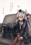  1girl amatsukaze_(kantai_collection) blanket brown_dress commentary_request couch dress feet_out_of_frame garter_straps hair_tubes hat highres kantai_collection kuuru_(kuuru-n) long_hair looking_at_viewer mini_hat plaid red_legwear sailor_dress short_dress silver_hair simple_background sitting smokestack_hair_ornament solo striped striped_legwear thigh-highs translation_request two_side_up white_background windsock 