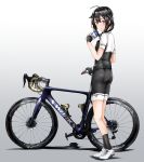  1girl adapted_costume ahoge bicycle bike_shorts black_gloves black_hair black_legwear black_shirt black_shorts blue_eyes braid fingerless_gloves full_body gloves ground_vehicle hair_flaps hair_over_shoulder highres kantai_collection kazu_(really_in_hot_water_now) multicolored_shirt remodel_(kantai_collection) shigure_(kantai_collection) shirt shoes short_sleeves shorts single_braid sneakers socks solo standing white_footwear white_shirt 