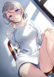  1girl :o absurdres black_shorts blue_eyes chair commentary_request dutch_angle grey_hair hand_on_own_knee highres knee_up lens_flare long_sleeves looking_at_viewer love_live! love_live!_sunshine!! playing_with_own_hair shirt short_hair short_shorts shorts sitting solo watanabe_you white_shirt window yamaori_(yamaorimon) 