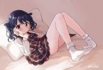  1girl bangs bare_legs black_hair commentary_request dress dutch_angle eluthel fukumaru_koito highres idolmaster idolmaster_shiny_colors long_sleeves looking_at_viewer medium_hair on_bed pillow plaid plaid_dress socks solo thighs twintails violet_eyes white_legwear 