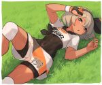  1girl bangs black_bodysuit black_hairband blush bodysuit bodysuit_under_clothes border breasts chorefuji clothes_writing covered_navel gloves grass grey_eyes grey_hair hairband knee_pads lying on_back open_mouth partly_fingerless_gloves pokemon pokemon_(game) pokemon_swsh saitou_(pokemon) shirt short_hair short_sleeves shorts single_glove solo sweat tied_shirt two-tone_gloves white_border 