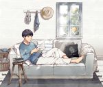  1boy absurdres barefoot basket black_hair blue_sweater book_stack couch cup food fruit furuya01boy grey_eyes hat hat_removed headwear_removed highres indoors lantern male_focus mug original pants pillow reading rug scenery sitting solo stool sweater tree white_pants window 