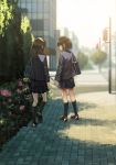  2girls bag black_hair black_legwear blurry cityscape commentary_request crosswalk depth_of_field facing_away facing_to_the_side flower kagumanikusu kneehighs long_hair multiple_girls original outdoors scenery school_bag school_uniform short_hair walking 