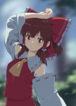  1girl arm_on_head arm_up ascot bangs blurry blurry_background blush bow brown_eyes brown_hair bush check_commentary closed_mouth commentary_request cowboy_shot detached_sleeves frilled_bow frilled_shirt_collar frills hair_between_eyes hair_bow hair_tubes hakurei_reimu hand_on_own_head highres large_bow leaning_back leaning_to_the_side long_sleeves looking_at_viewer medium_hair outdoors outstretched_arm red_bow red_shirt red_skirt ribbon ribbon-trimmed_collar ribbon-trimmed_sleeves ribbon_trim shiratama_(hockey) shirt sidelocks skirt skirt_set sleeveless sleeveless_shirt solo touhou wide_sleeves yellow_neckwear yellow_ribbon 