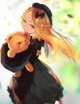  1girl abigail_williams_(fate/grand_order) backlighting bangs black_bow black_dress black_headwear blonde_hair blue_eyes blurry blurry_background blush bow breasts closed_mouth dress fate/grand_order fate_(series) forehead hair_bow hat highres long_hair long_sleeves looking_at_viewer multiple_bows okoru_ringo orange_bow parted_bangs ribbed_dress sleeves_past_wrists small_breasts stuffed_animal stuffed_toy teddy_bear 