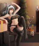  1girl animal_ears arknights arm_up bandeau bangs bare_arms bare_shoulders black_legwear black_shorts blurry blurry_background box breasts brown_eyes cat_ears ceylon_(arknights) chair character_doll christmas_tree commentary_request feet_out_of_frame garter_straps gift gift_box hair_between_eyes highres indoors long_hair medium_breasts micro_shorts midriff navel no_shoes schwarz_(arknights) shorts silver_hair sitting solo stomach strapless thigh-highs thighs tubetop zhi_wozi 