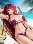  1girl armpits beach beach_chair bikini blue_sky breasts drink easonx fate/grand_order fate_(series) flower hair_flower hair_intakes hair_ornament hibiscus highres large_breasts long_hair looking_at_viewer navel ocean palms purple_bikini reclining red_eyes scathach_(fate)_(all) scathach_(swimsuit_assassin)_(fate) sky solo sweat swimsuit 