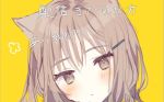  1girl animal_ears bangs blush cat_ears close-up closed_mouth hair_between_eyes hair_ornament hairclip kawaii_rowa light_brown_eyes light_brown_hair long_hair looking_at_viewer original portrait simple_background solo text_focus translation_request yellow_background 