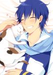  1boy bangs bed_sheet blue_hair blue_nails blush cat closed_eyes collarbone eyebrows_visible_through_hair from_below grin hair_between_eyes kaito long_sleeves lying male_focus nail_polish nokuhashi on_back shiny shiny_hair smile solo upper_body vocaloid 