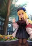  1girl bare_shoulders belt beret black_shirt blonde_hair blue_flower blue_headwear blue_rose blue_skirt blurry blurry_background blush breasts choker commentary_request eyebrows_visible_through_hair flower gem hair_ribbon hand_up hat highres hose izumi_roka jacket jewelry large_breasts long_hair looking_at_viewer nail_art open_clothes open_jacket open_mouth original oversized_clothes pantyhose ribbon rose shirt skirt solo tied_hair tongue tree waving white_jacket yellow_eyes 