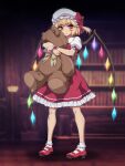  1girl blonde_hair blurry blurry_background closed_mouth crystal flandre_scarlet full_body hat highres library mob_cap ootsuki_wataru red_eyes red_footwear red_skirt shoes short_hair side_ponytail skirt socks solo standing stuffed_animal stuffed_toy teddy_bear touhou twitter_username white_headwear white_socks wings wrist_cuffs 