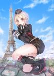  1girl absurdres armband black_footwear black_gloves black_headwear black_neckwear black_skirt blonde_hair blue_sky blush boots brown_eyes clouds cross-laced_footwear day eiffel_tower giantess girls_frontline gloves half_gloves hat highres knee_boots lace-up_boots landmark long_sleeves martinreaction military military_uniform mp40_(girls_frontline) necktie short_hair signature skirt sky socks solo uniform 
